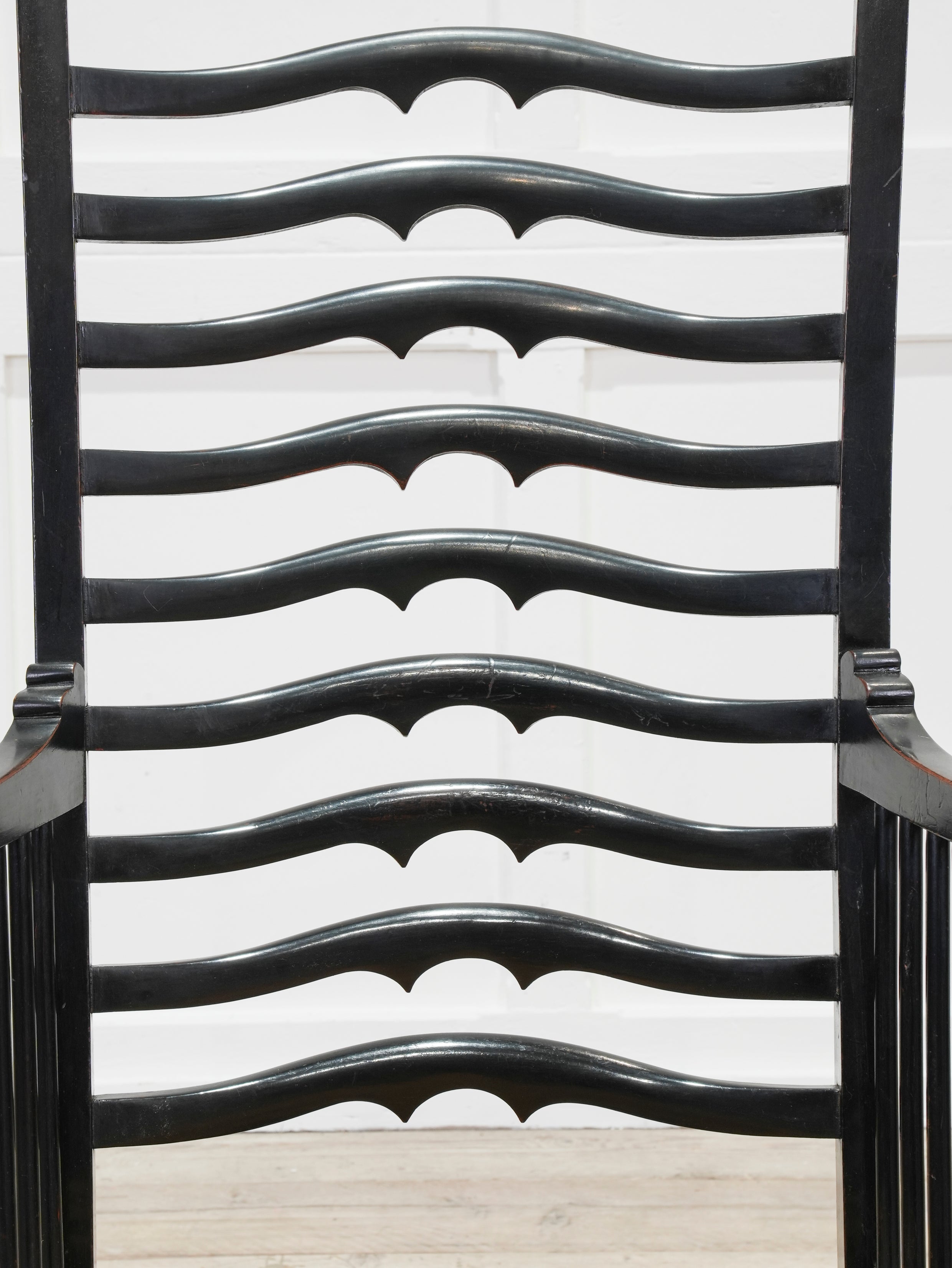An Ebonised Ladder Back Arm Chair