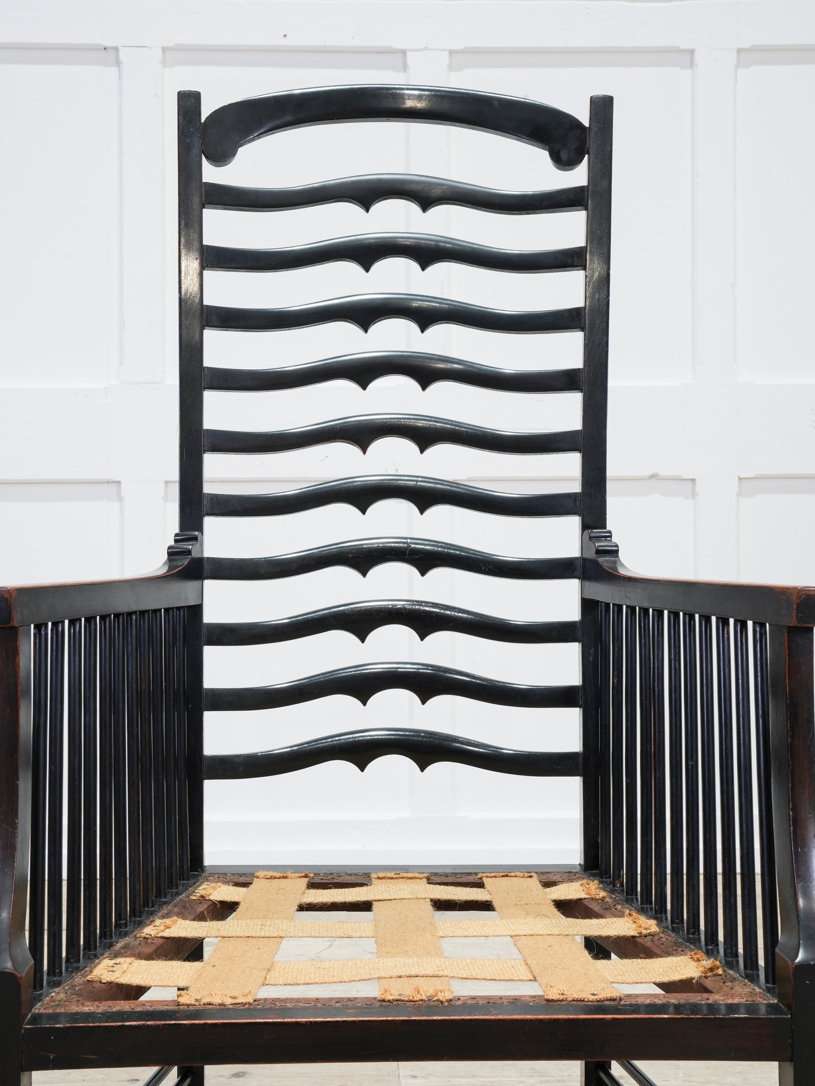 An Ebonised Ladder Back Arm Chair
