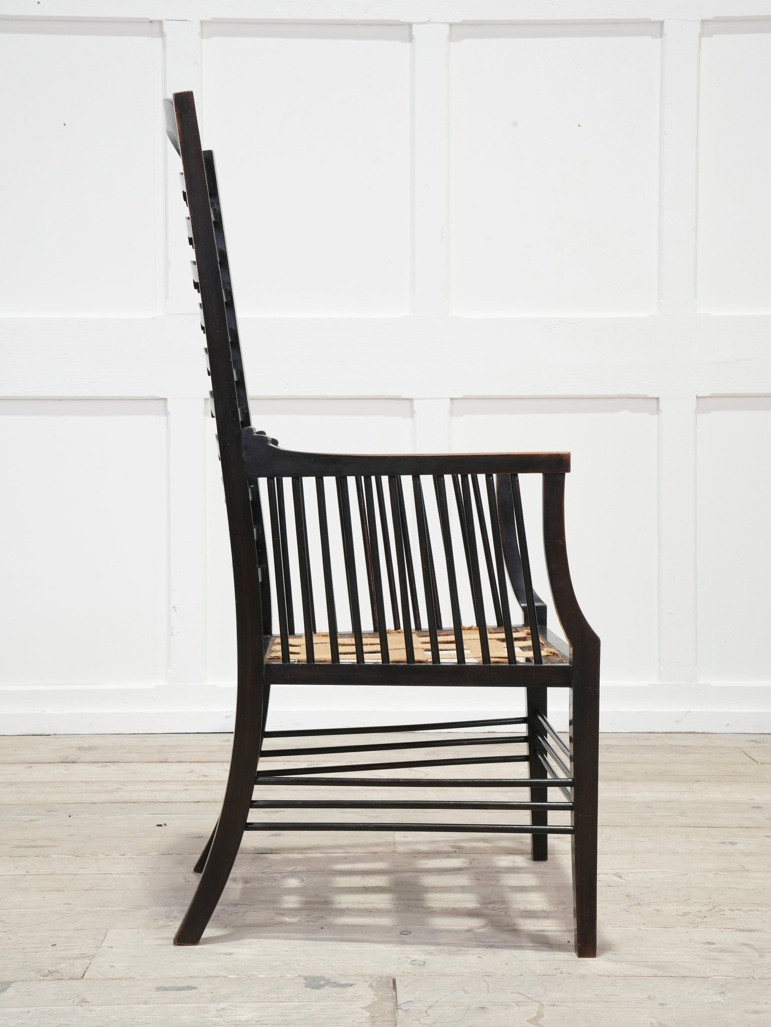 An Ebonised Ladder Back Arm Chair