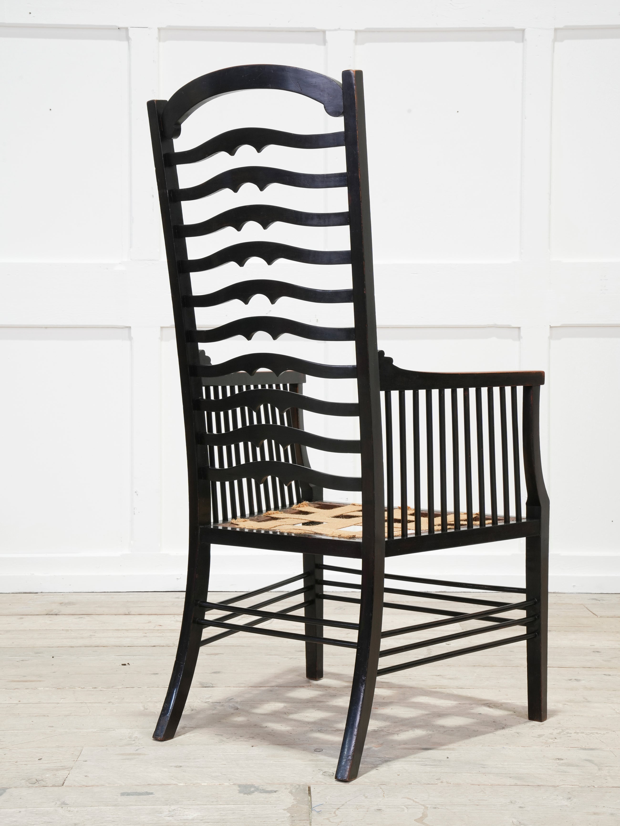 An Ebonised Ladder Back Arm Chair