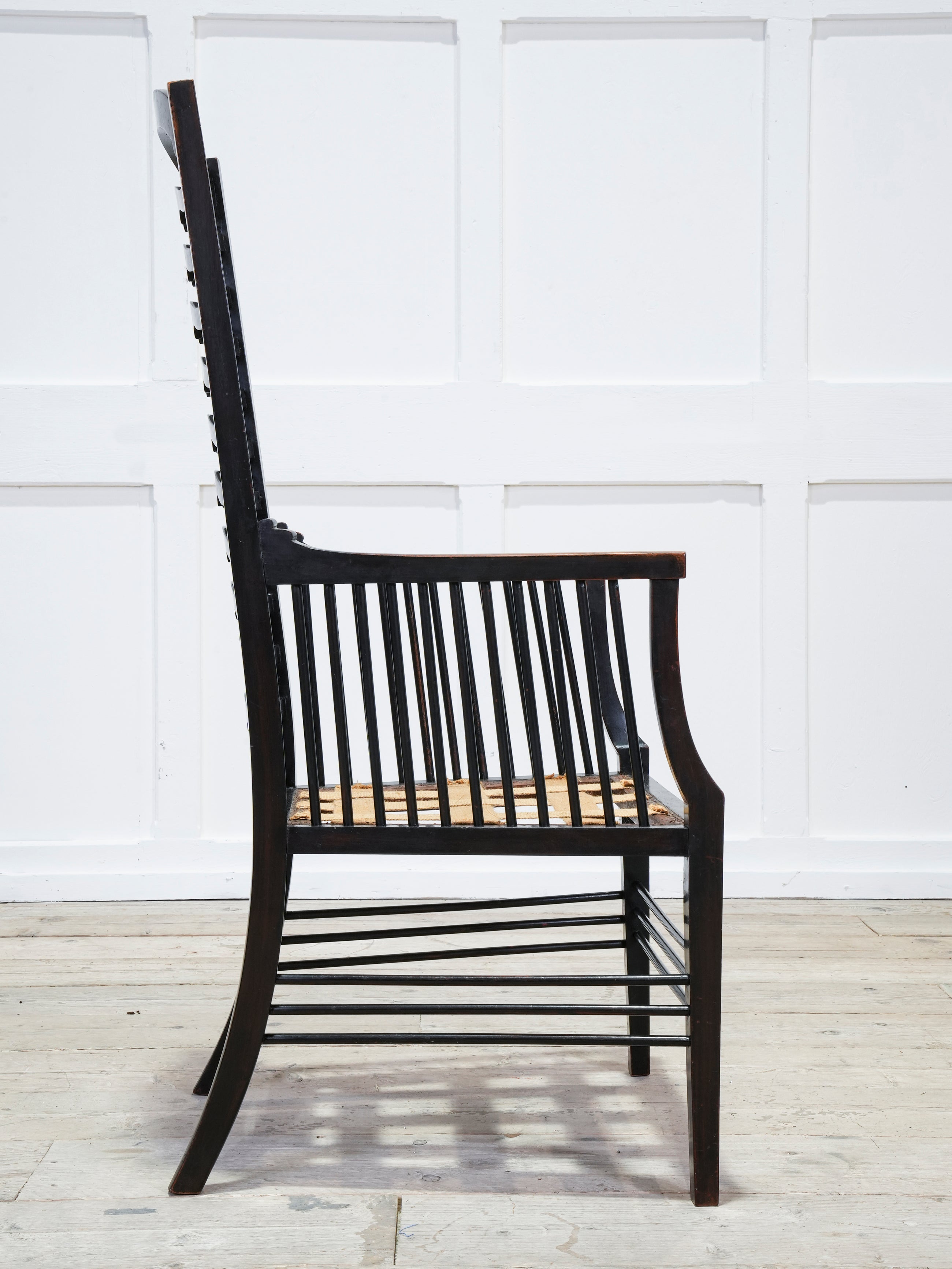 An Ebonised Ladder Back Arm Chair