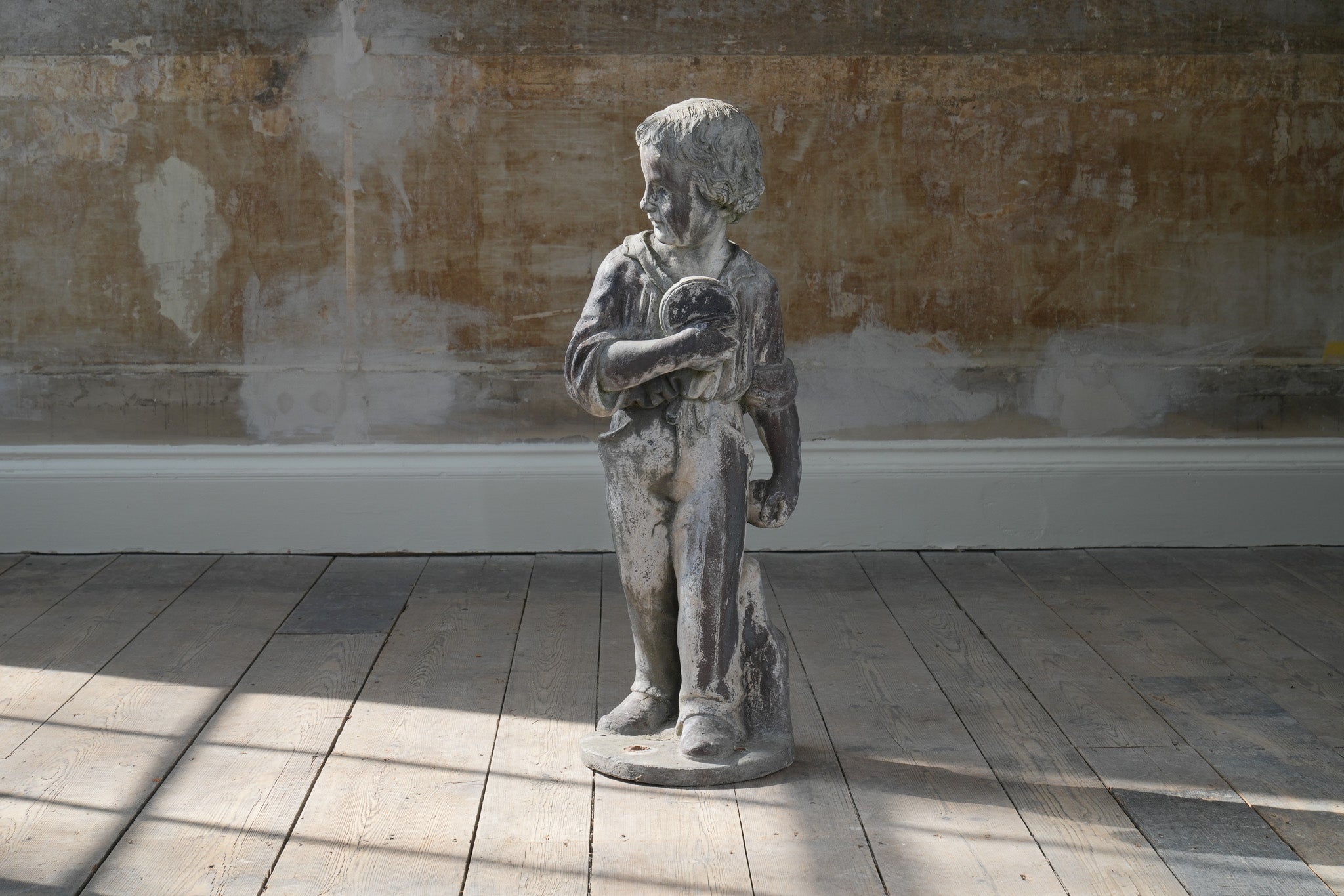 A Lead Statue of a Boy