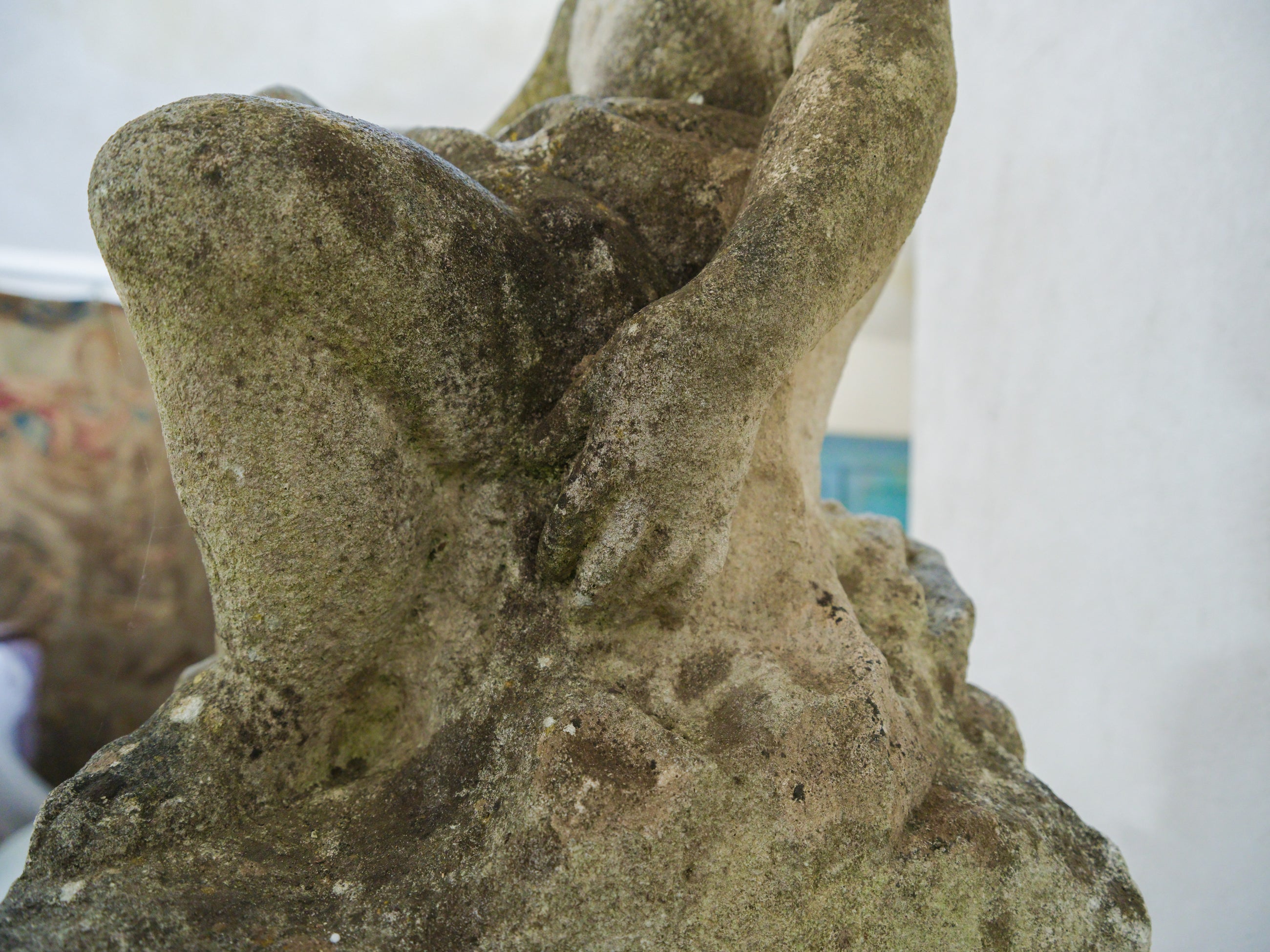 An 18th Century Limestone Putti on a Caen Stone Pillar