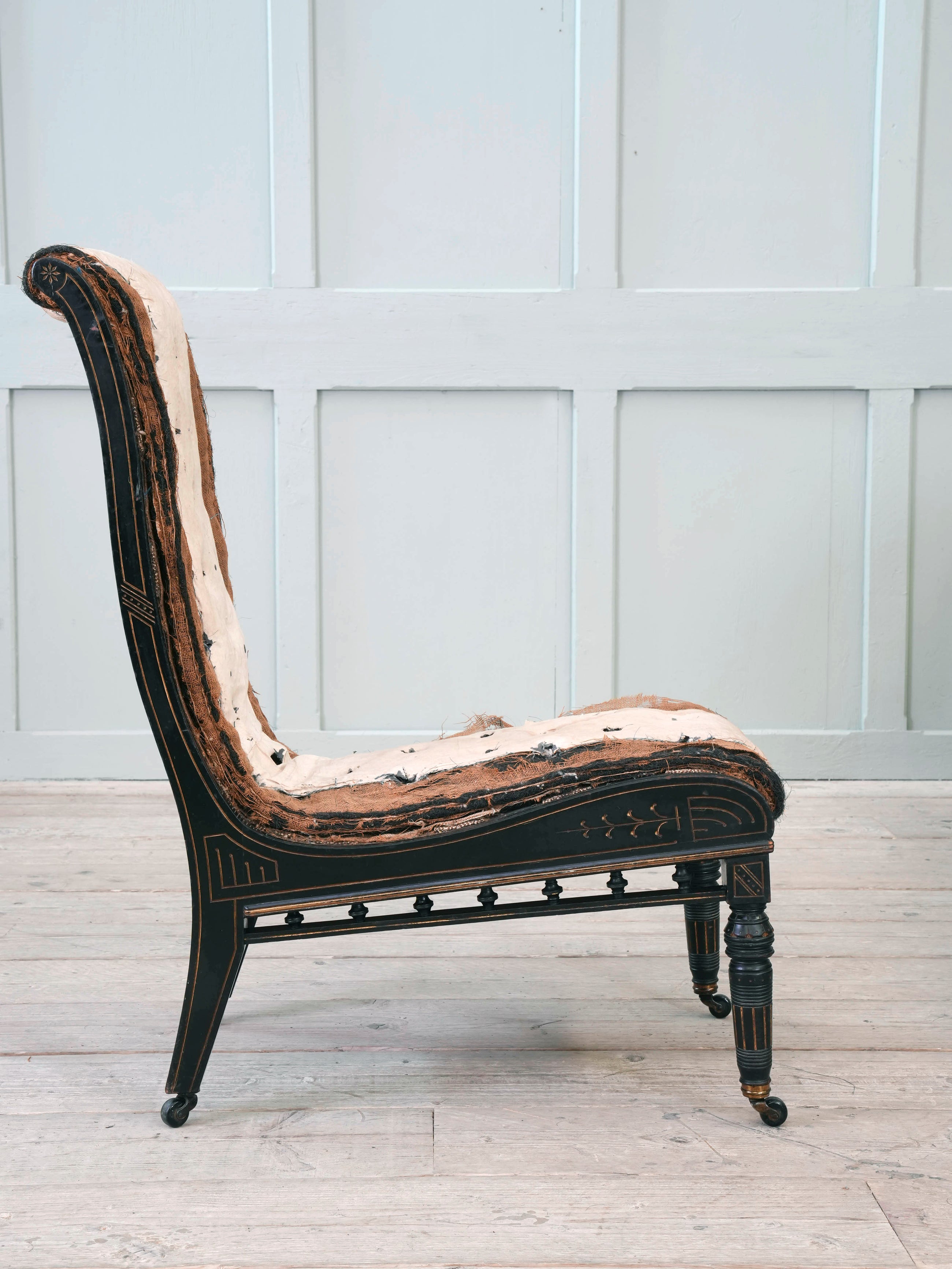 An Ebonised Aesthetic Movement Upholstered Chair