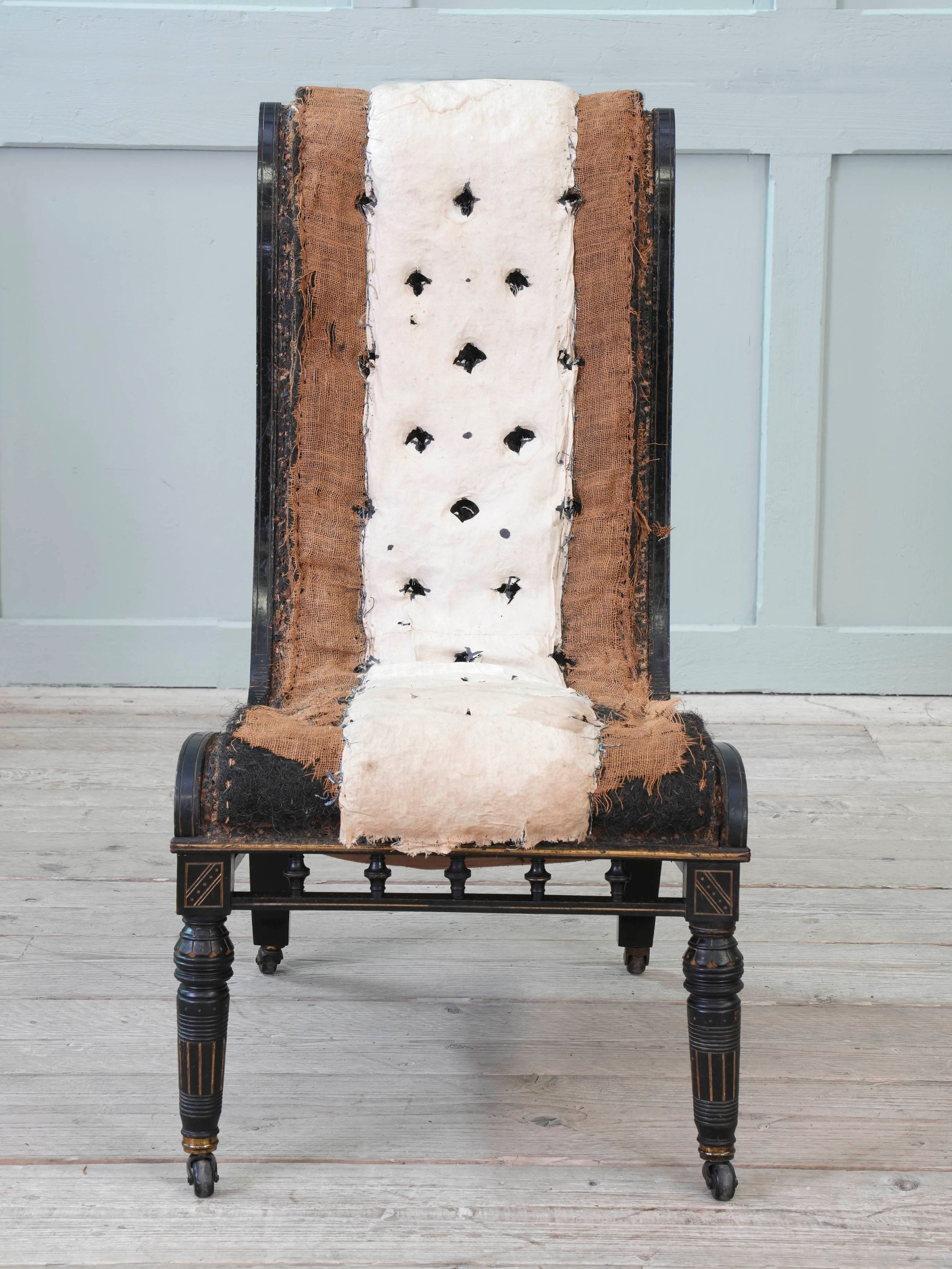 An Ebonised Aesthetic Movement Upholstered Chair