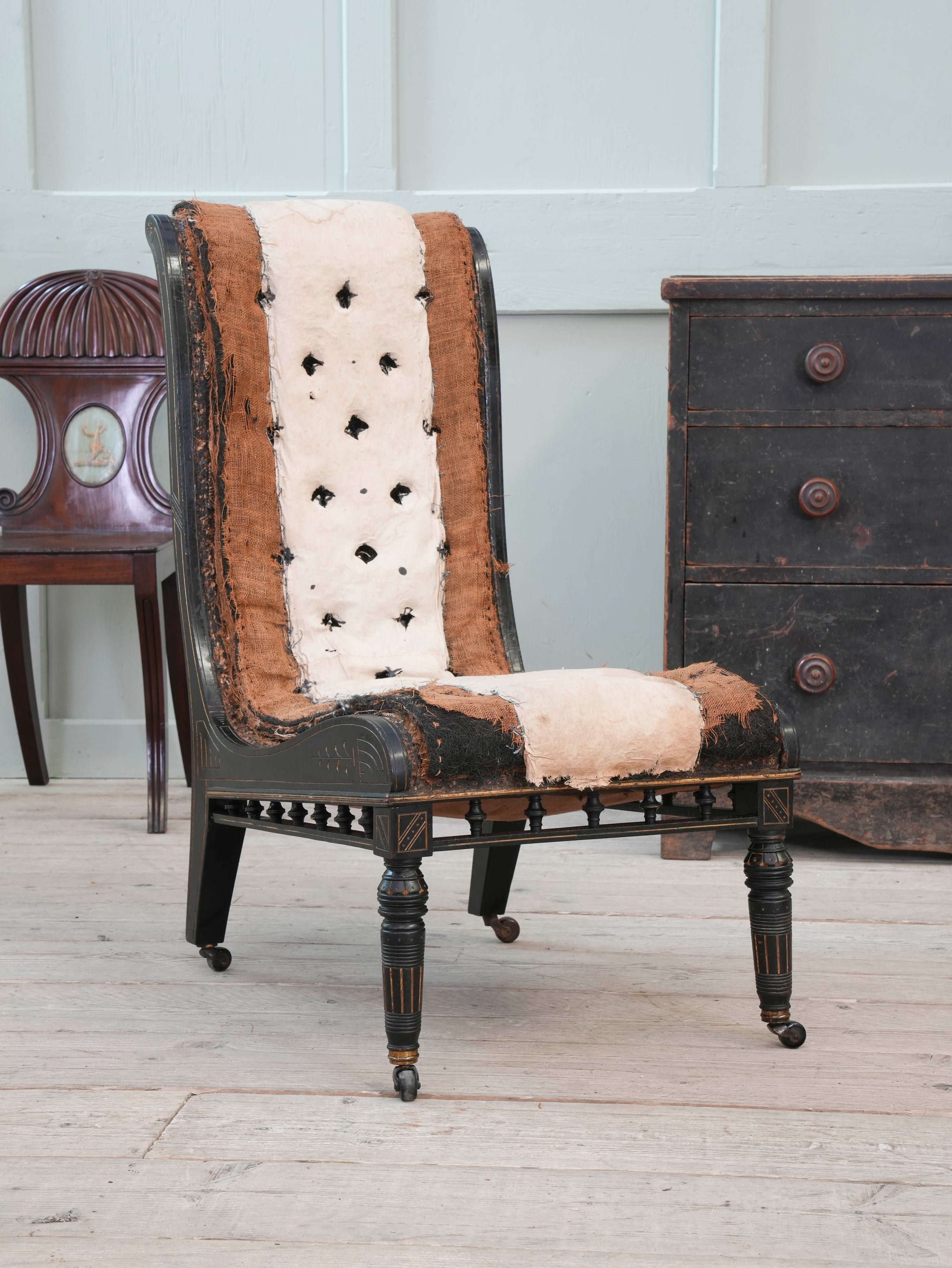 An Ebonised Aesthetic Movement Upholstered Chair