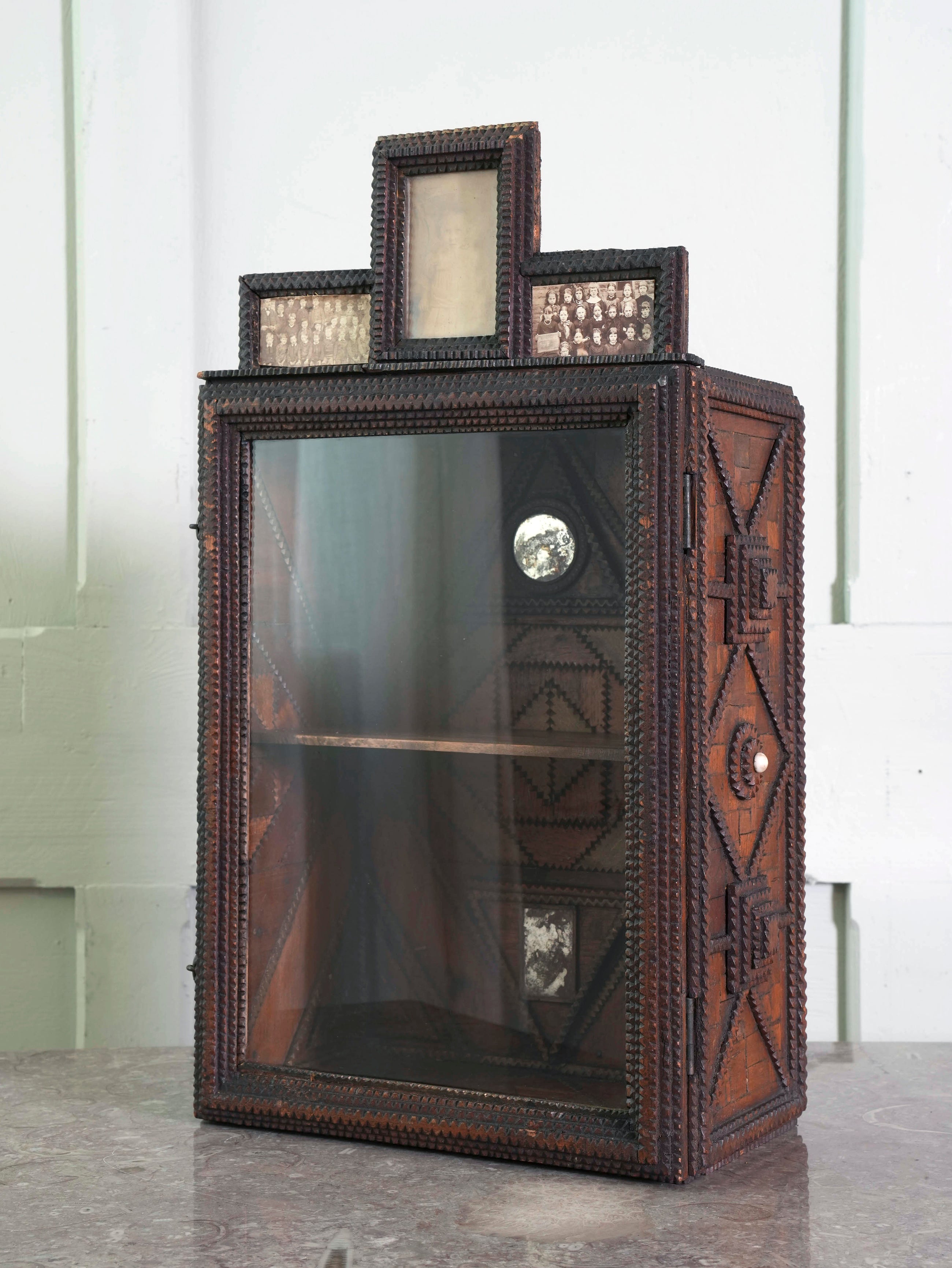 A Glazed Tramp Art Cabinet