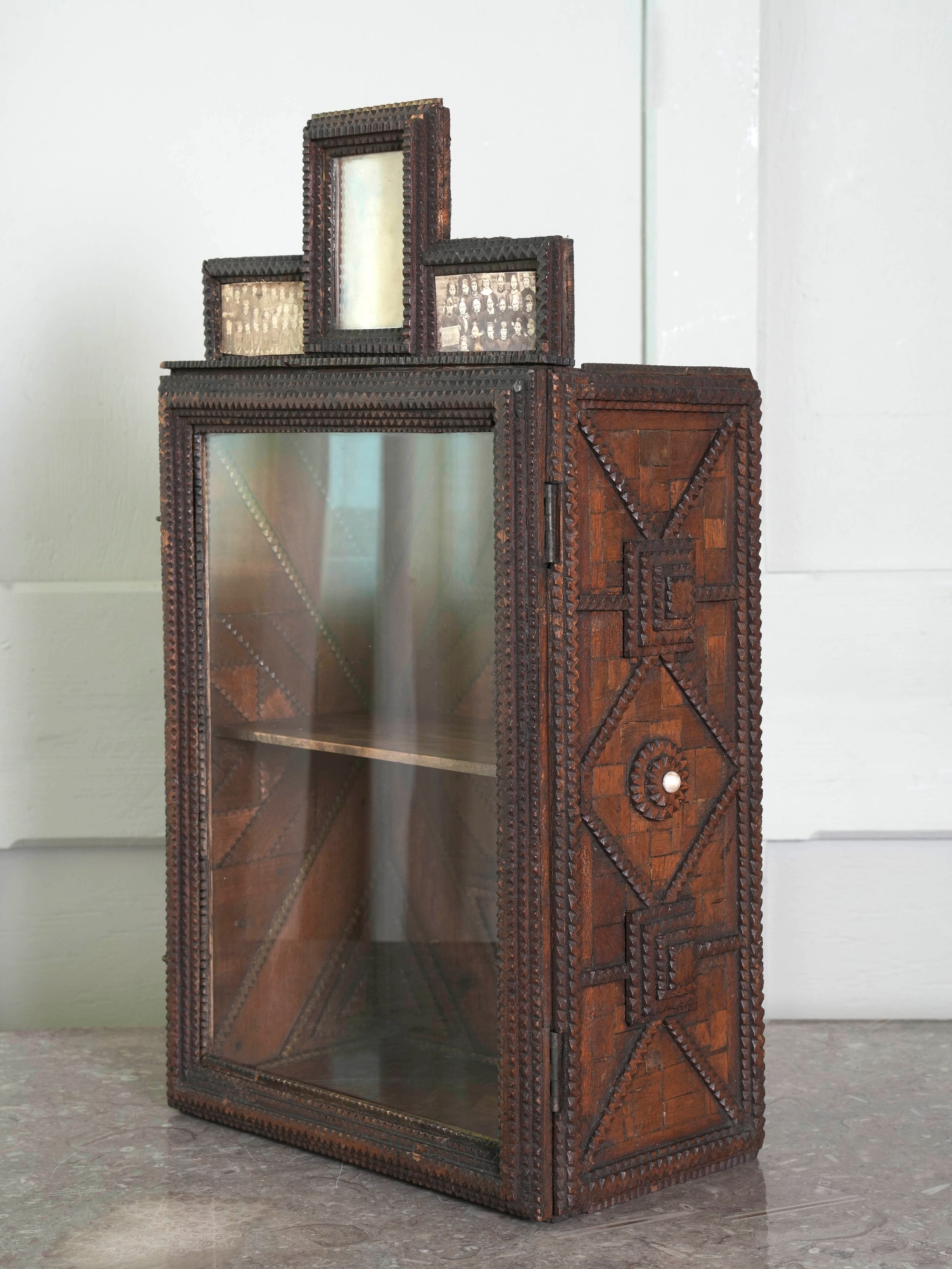 A Glazed Tramp Art Cabinet