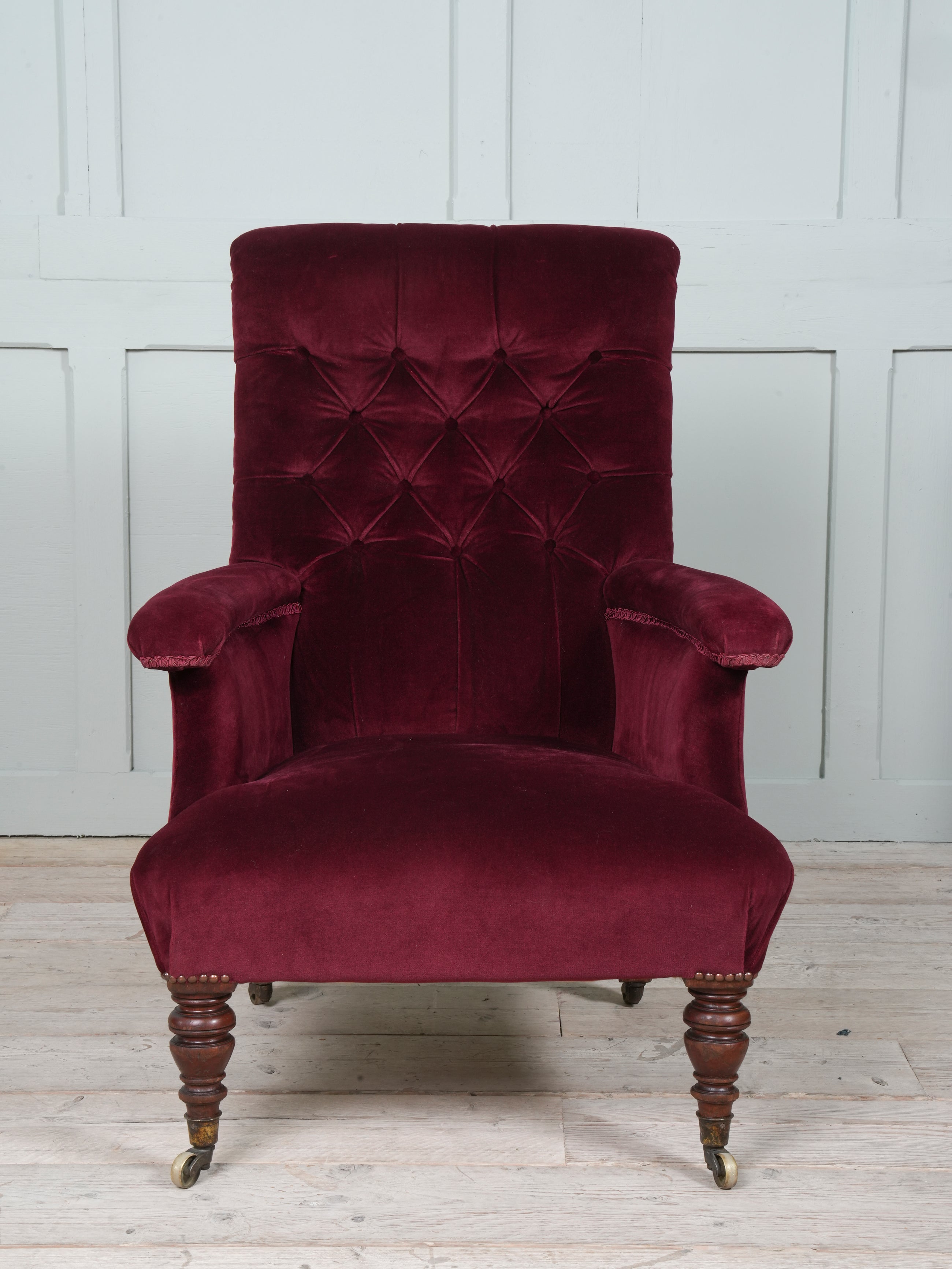 A Howard & Sons Buttoned Back Armchair