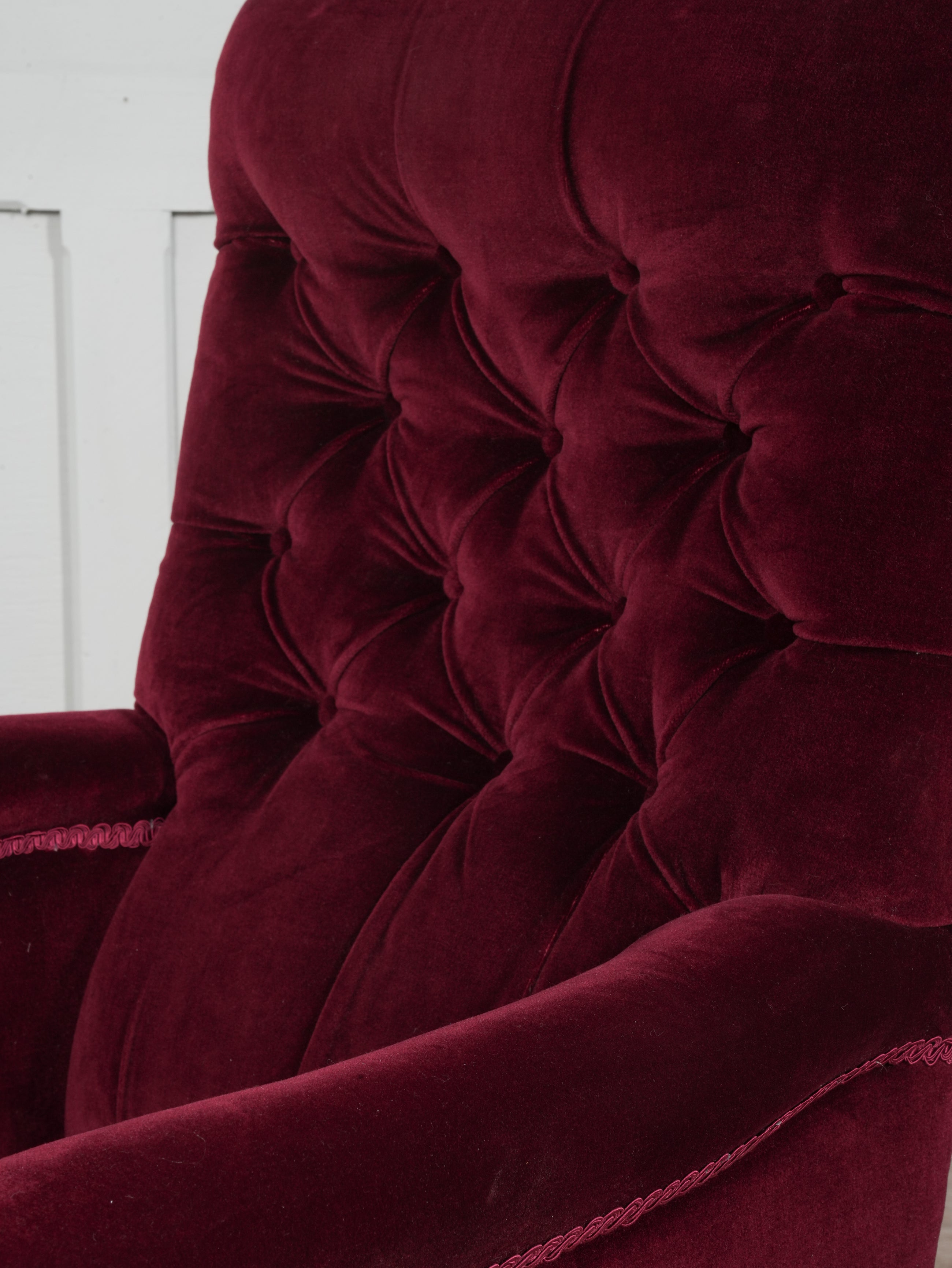 A Howard & Sons Buttoned Back Armchair