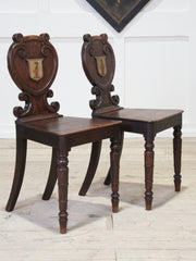 A Pair of 19th Century Oak Armorial Hall Chairs