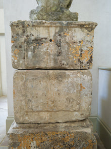 An 18th Century Limestone Putti on a Caen Stone Pillar