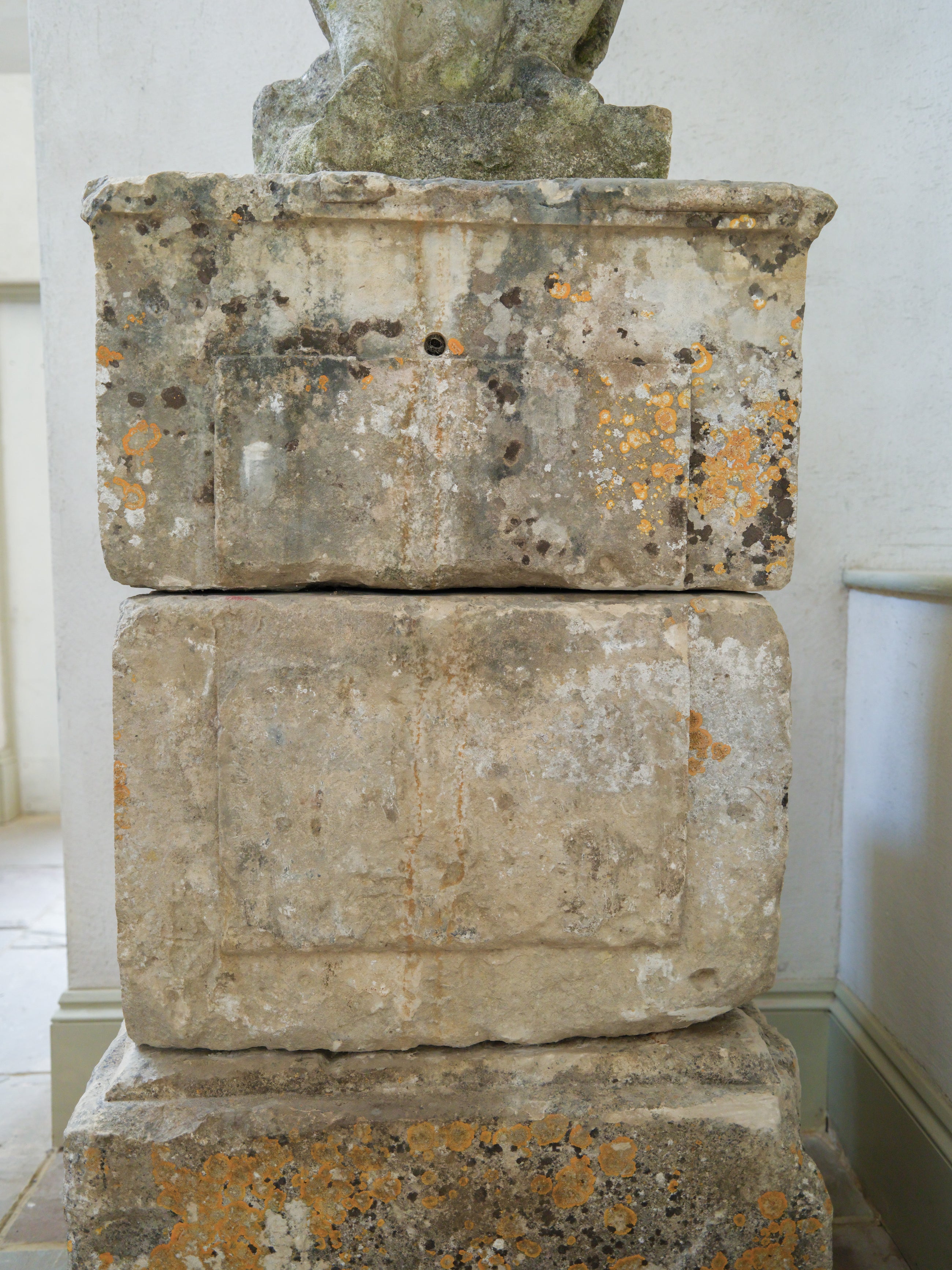 An 18th Century Limestone Putti on a Caen Stone Pillar