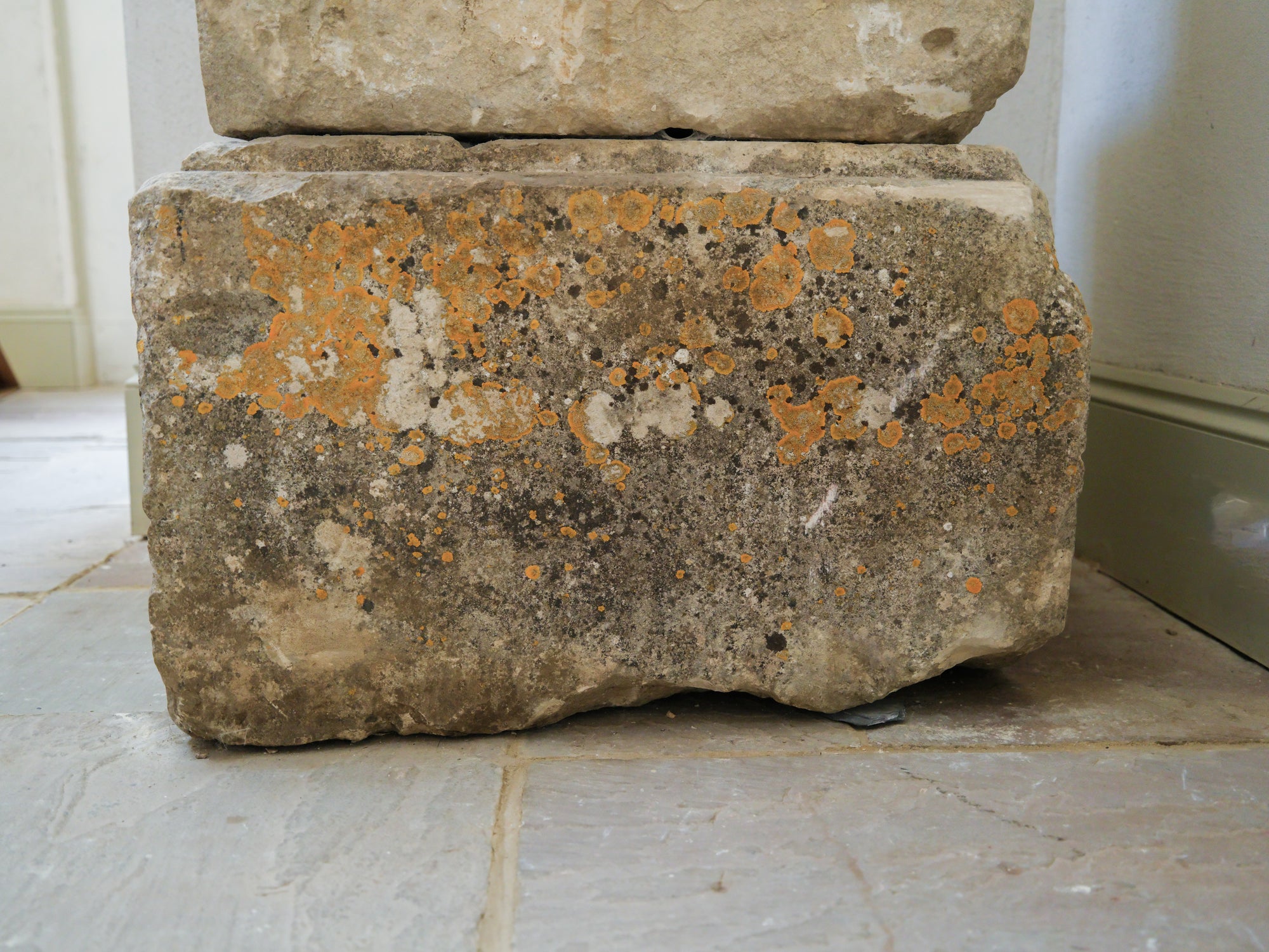 An 18th Century Limestone Putti on a Caen Stone Pillar