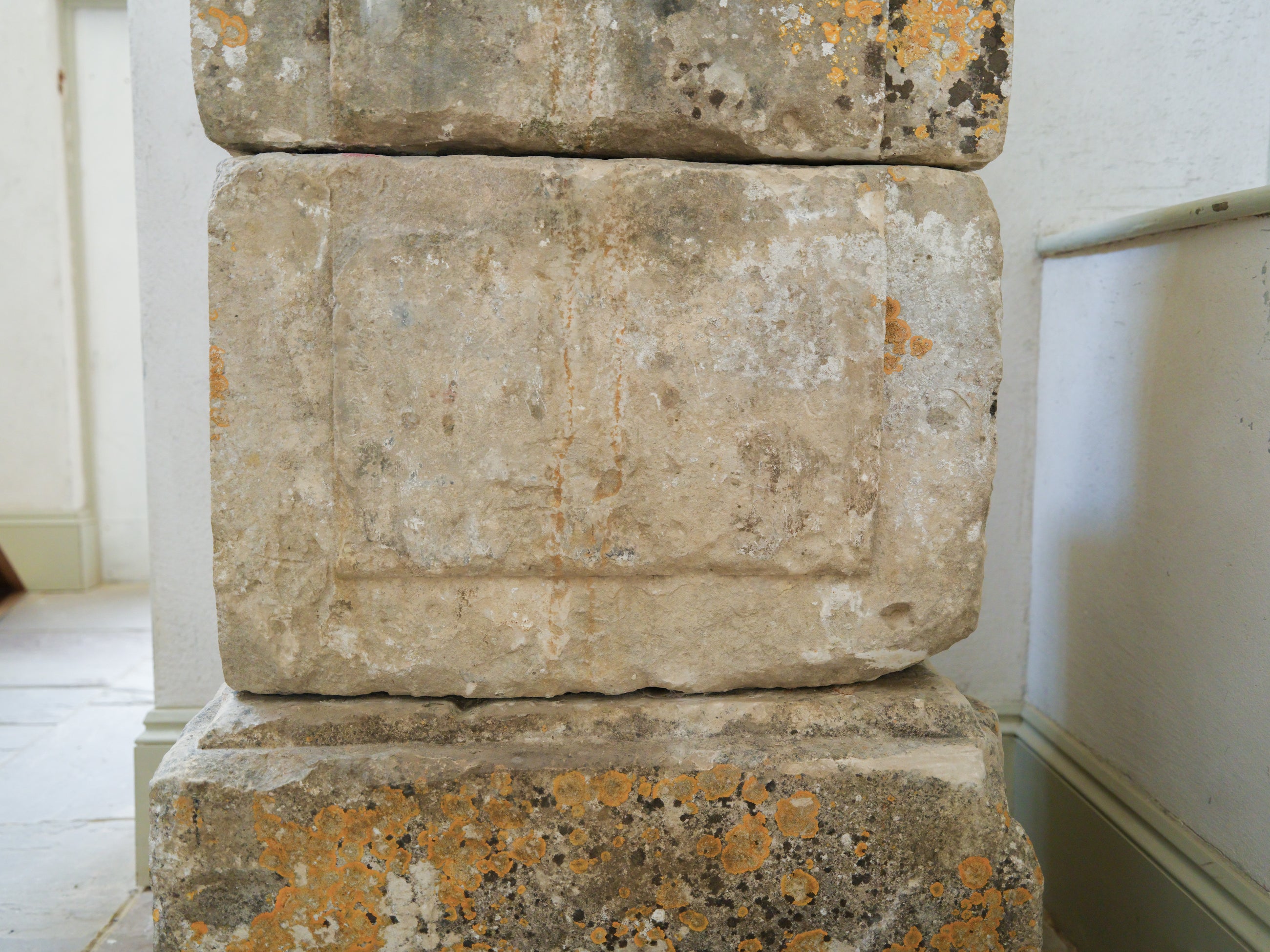An 18th Century Limestone Putti on a Caen Stone Pillar