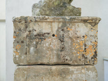 An 18th Century Limestone Putti on a Caen Stone Pillar