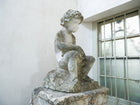 An 18th Century Limestone Putti on a Caen Stone Pillar