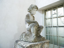 An 18th Century Limestone Putti on a Caen Stone Pillar