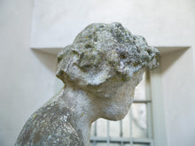 An 18th Century Limestone Putti on a Caen Stone Pillar