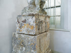 An 18th Century Limestone Putti on a Caen Stone Pillar