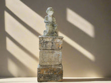 An 18th Century Limestone Putti on a Caen Stone Pillar