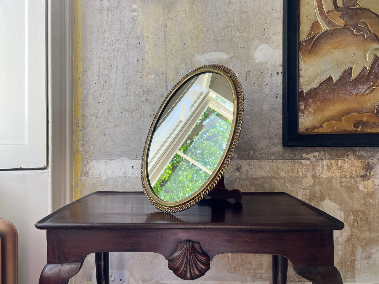 A large Brass Ring Easel Mirror