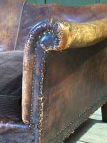 A Large Leather Camelback Sofa