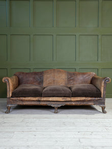 A Large Leather Camelback Sofa