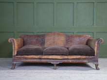 A Large Leather Camelback Sofa