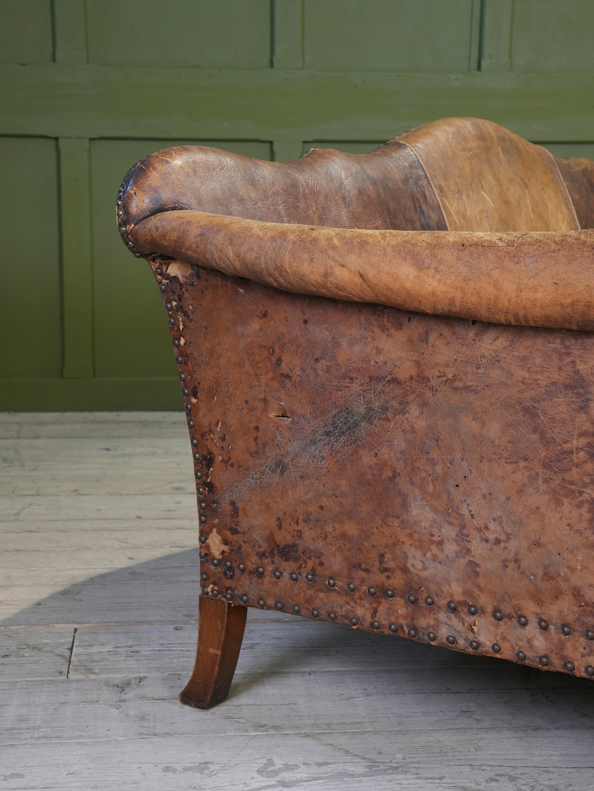 A Large Leather Camelback Sofa