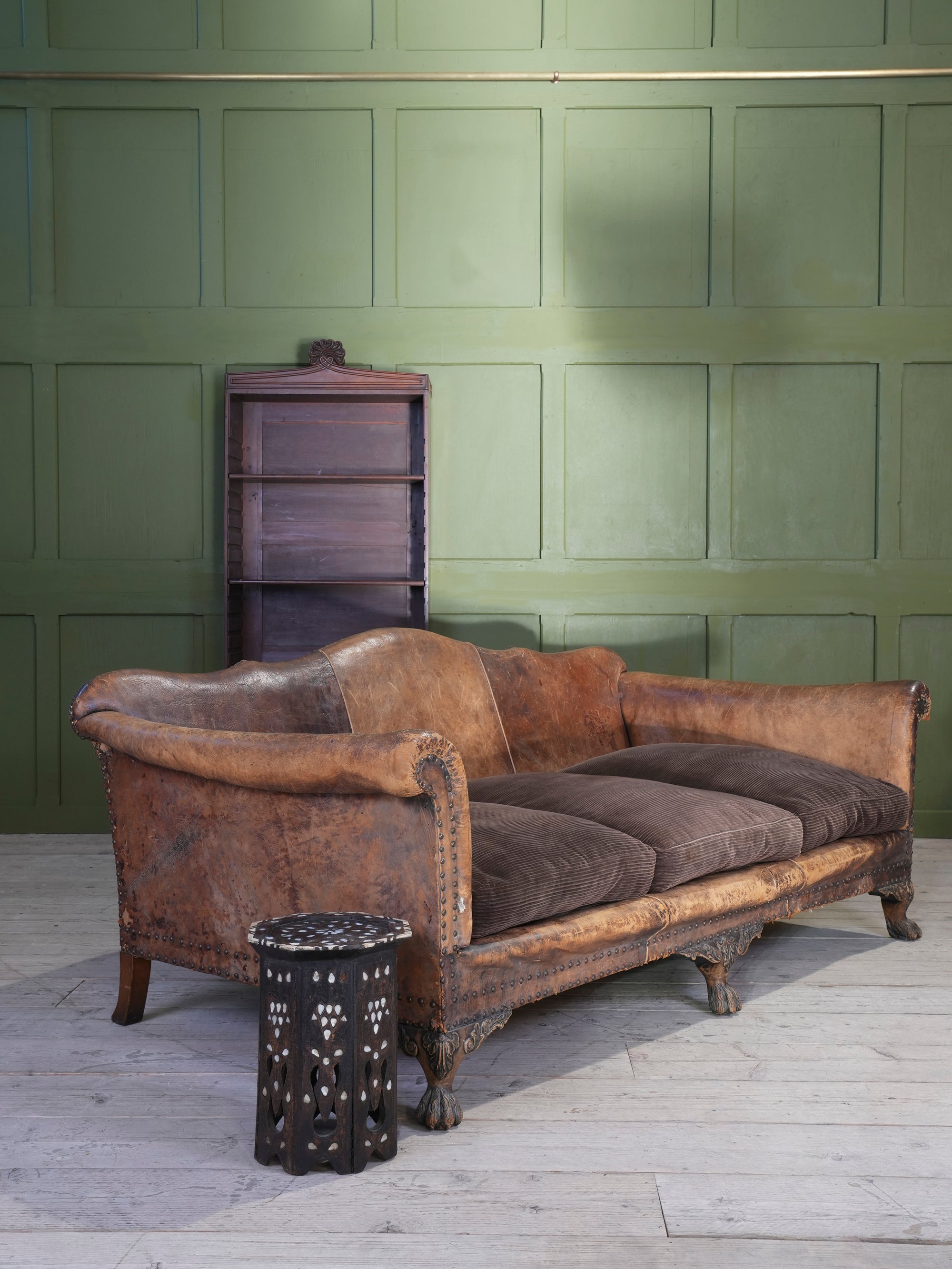 A Large Leather Camelback Sofa