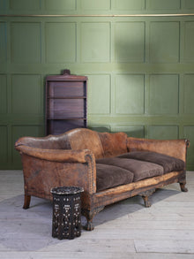 A Large Leather Camelback Sofa