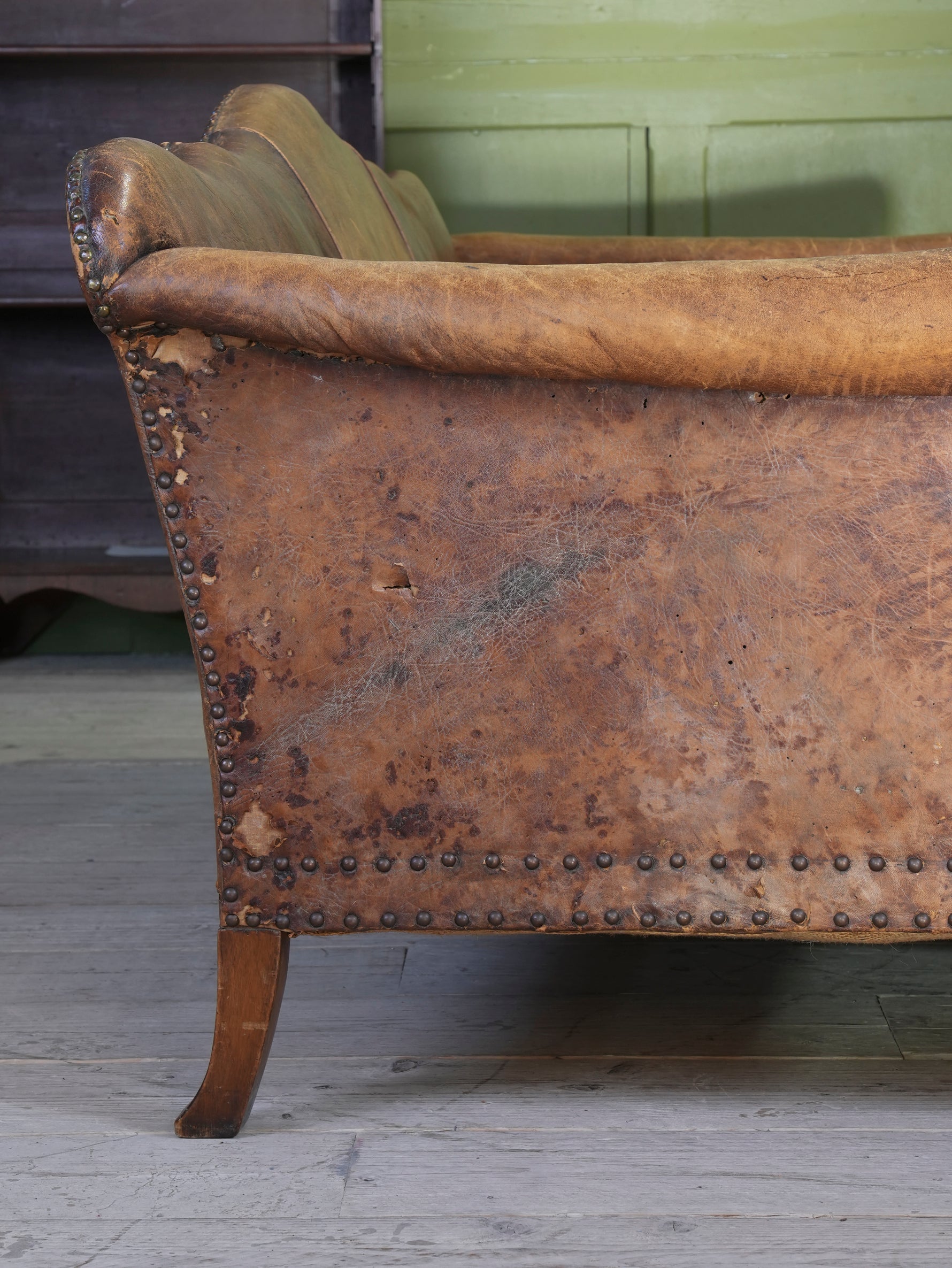 A Large Leather Camelback Sofa