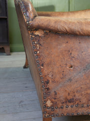A Large Leather Camelback Sofa