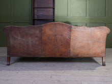 A Large Leather Camelback Sofa