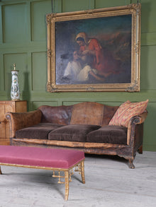 A Large Leather Camelback Sofa
