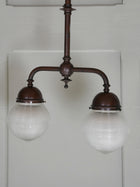 A Twin Holophane Ceiling Light