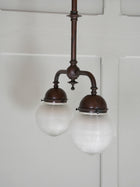 A Twin Holophane Ceiling Light