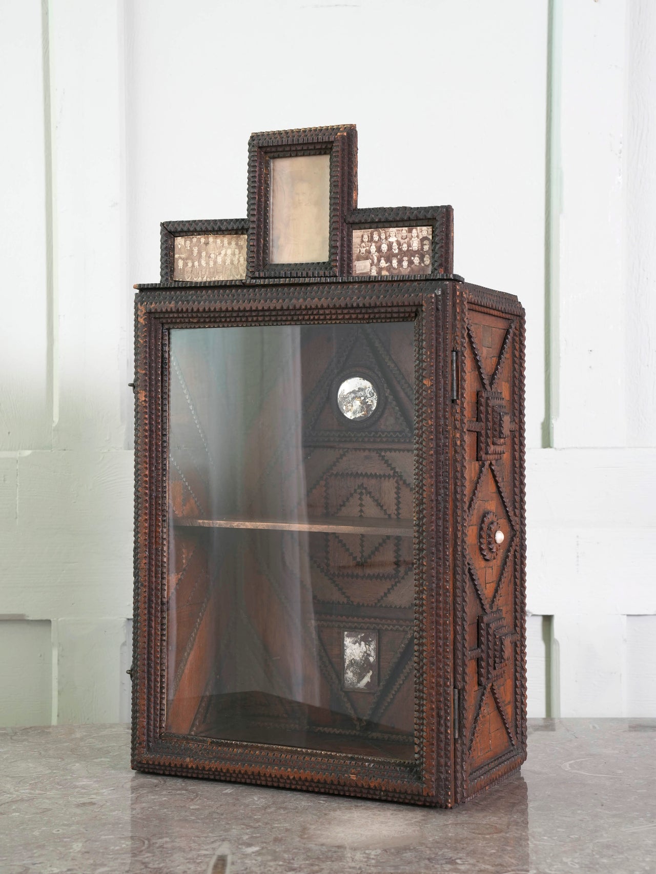 A Glazed Tramp Art Cabinet