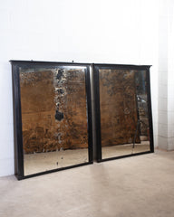 A Pair of Ebonised Mirrors
