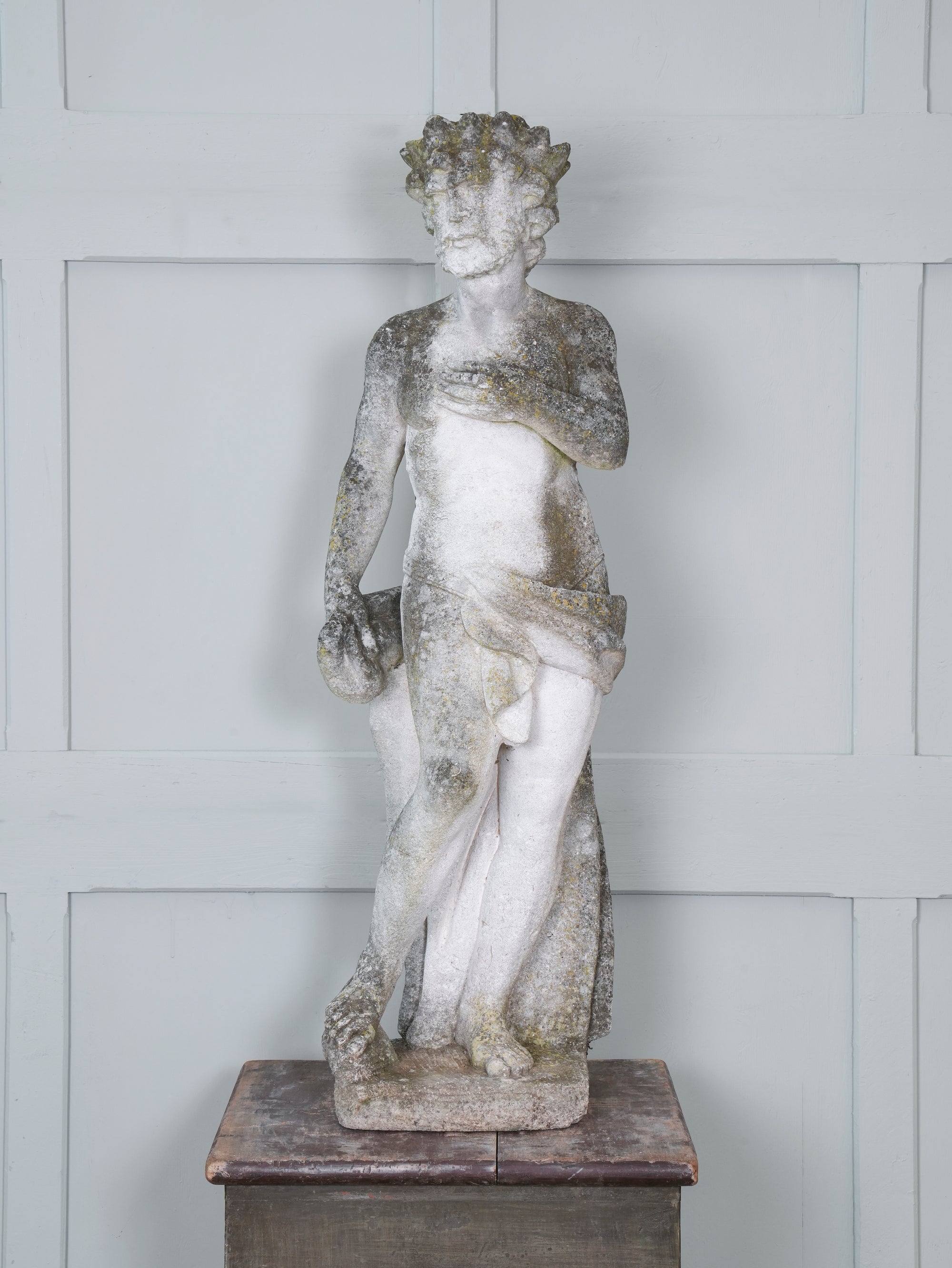 A Carved Stone Standing Male Figure with Crown