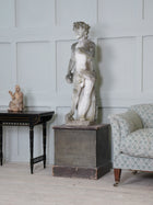 A Carved Stone Standing Male Figure with Crown
