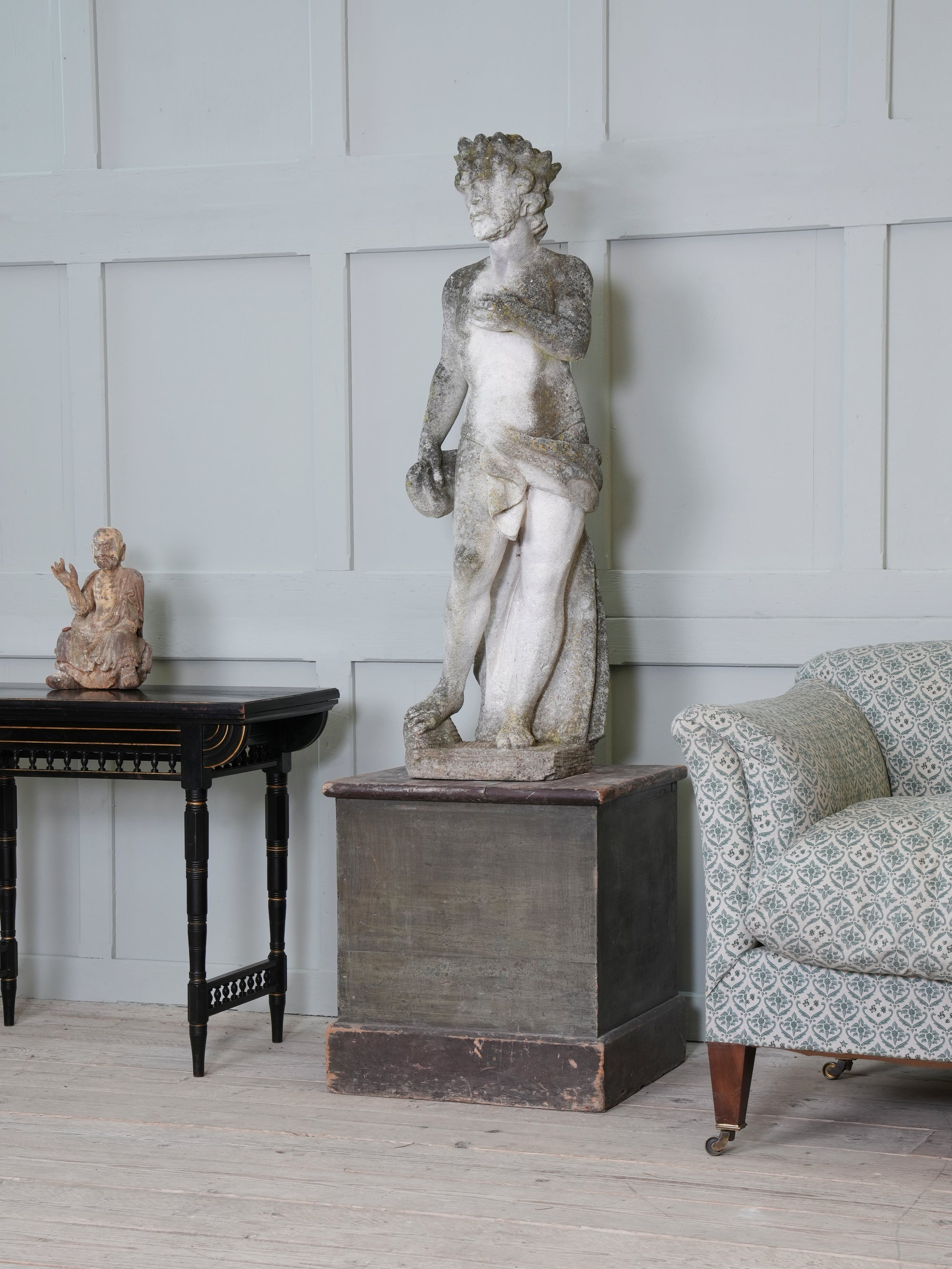 A Carved Stone Standing Male Figure with Crown