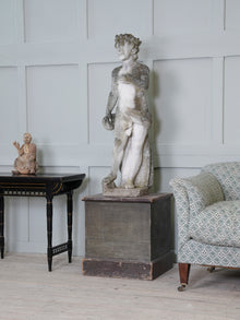 A Carved Stone Standing Male Figure with Crown